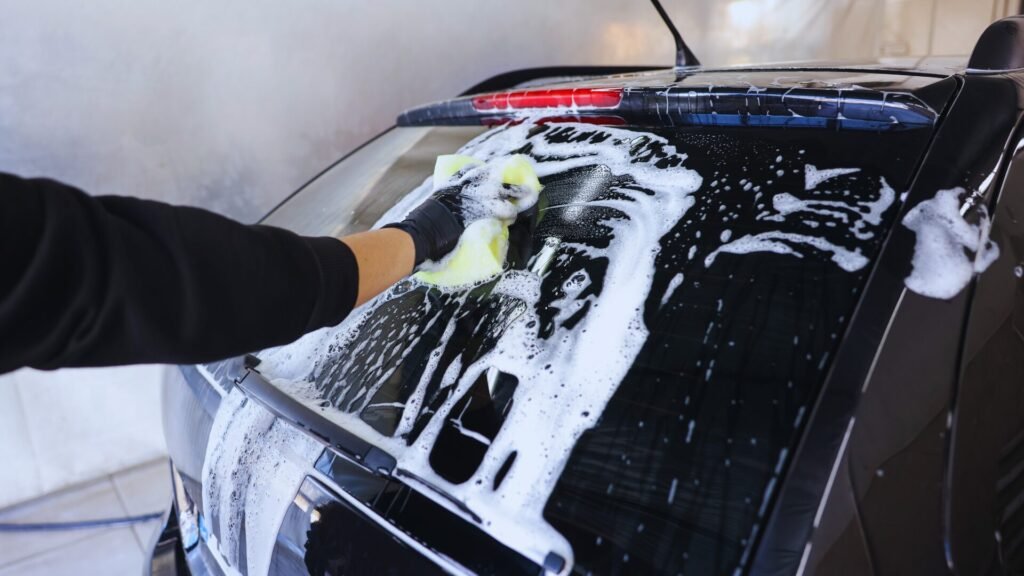 Black car engine bay with work gloves for ppf near me.